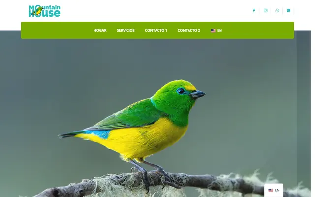 Página de inicio de Mountain House con un ave verde y amarilla en una rama